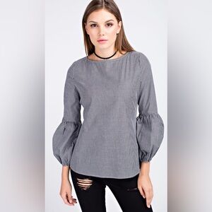 Black and white checkered top with accent sleeve